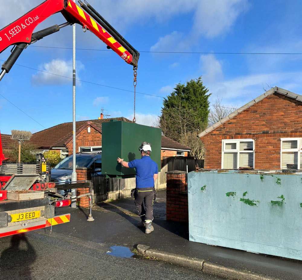 Crane moving an oil boiler in Preston