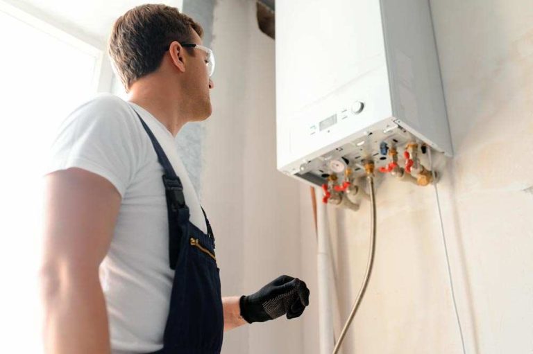Engineer inspecting a wall-mounted gas boiler