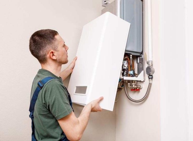 Engineer fitting a new wall-mounted gas boiler