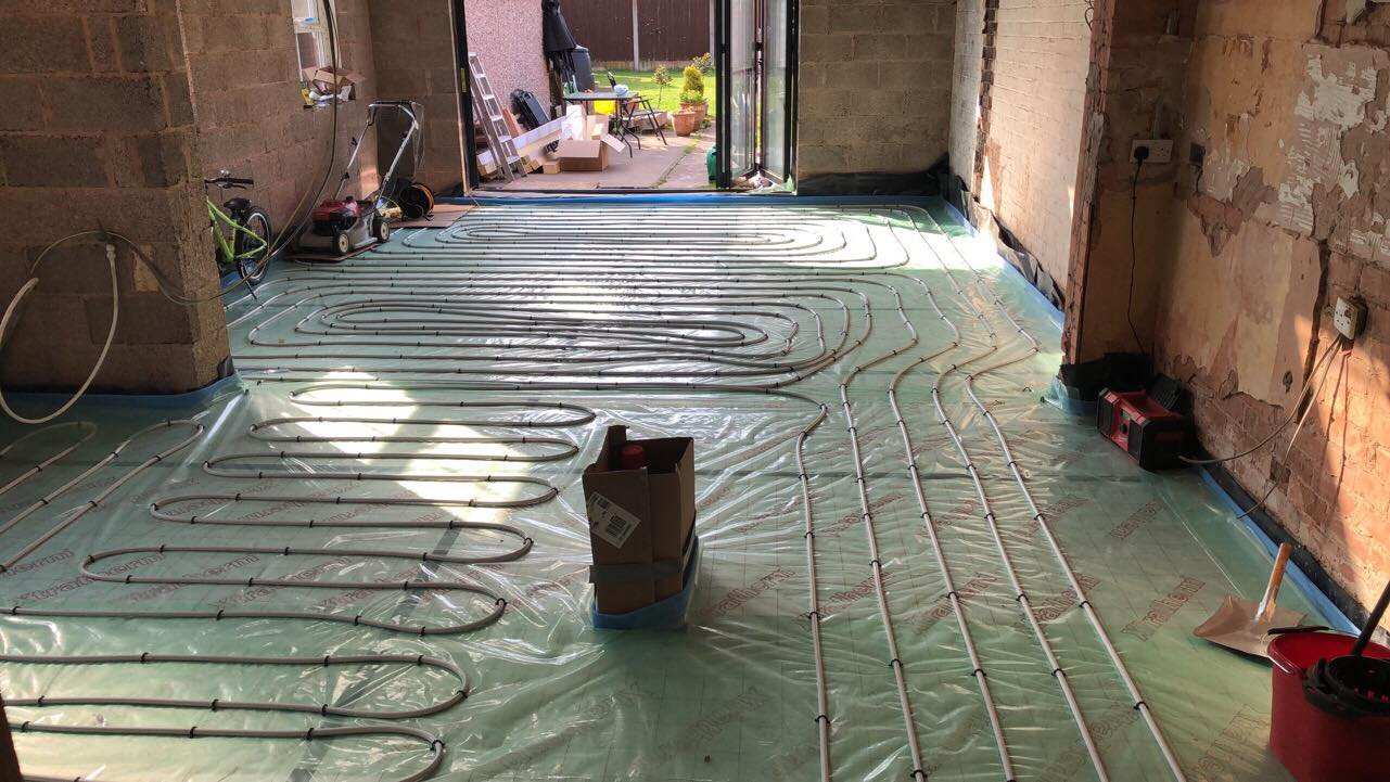Underfloor heating pipes laid across a floor
