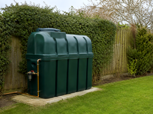 Green domestic oil tank in a back garden